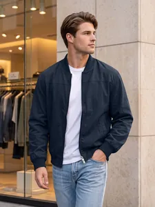 Men's dark navy bomber jacket with zipper pockets, worn by model in urban setting