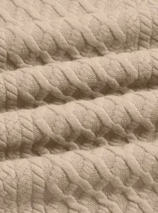 Macro view of textured beige jacquard knit fabric for men's athletic sweatshirt