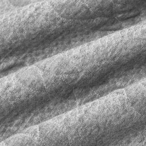 Macro detail van de grijze zware jacquard gebreide stof met een vintage textuur