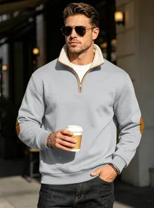 Detail view of men's light grey half-zip sweatshirt with fleece lining and elbow patches