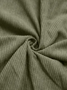 Macro detail shot showing the soft ribbed texture of the olive green corduroy fabric