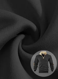 Detailed macro view of black cotton fabric texture for men's half-zip sweatshirt