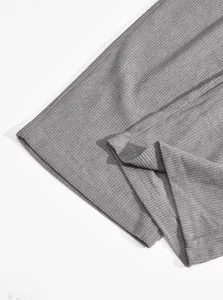 Macro detail of gray corduroy fabric and hem stitching on men's straight-leg cargo pants