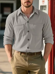 Close-up of men's grey corduroy shirt with heavy texture and double chest pockets