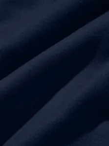 Close-up macro shot of the soft navy blue fabric texture on cargo pants