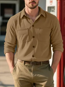 Detailed view of men's heavy corduroy long-sleeve shirt in khaki showing chest pockets