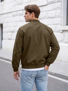 Detailed back view of a men's olive green flight bomber jacket in a street setting