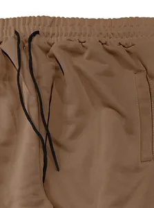 Close-up detail of men's brown casual trousers showing waistband and drawstring
