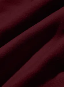 Macro detail showing the soft burgundy fabric texture of these men's cargo pants.