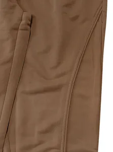 Macro view of brown fabric texture and seam detail of men's loose casual joggers.