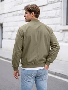 Close-up back view of a men's classic olive green bomber jacket in an outdoor urban setting