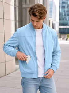 Detail view of light blue men's bomber jacket showing side pocket storage with phone