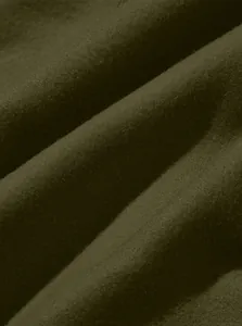 Close-up macro shot of dark olive green high-quality cargo pants fabric texture