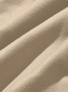 Detailed macro view of the soft and breathable fleece fabric texture for men's beige joggers