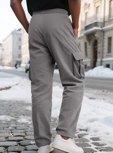 Detail view of grey men's corduroy cargo pants with side pockets in street scene
