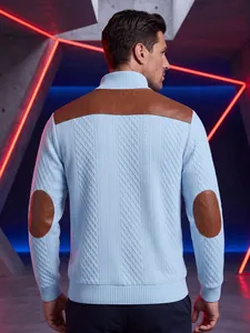 Detail of light blue men's knitted sweater featuring textured jacquard and leather patches