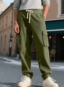 Detailed view of men's olive green corduroy cargo pants featuring drawstring and pockets