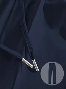 Close-up detail of navy blue sweatpants drawstring showing metallic silver aglets and fabric