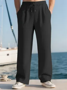 Men's black pleated straight casual trousers with drawstring waist in nautical setting