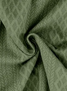 Vista macro della trama del tessuto jacquard verde traspirante per pantaloni sportivi uomo