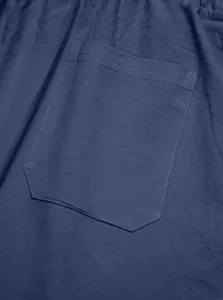 Detailaufnahme von marineblauem Leinenstoff mit Taschennaht an einer Herrenhose.