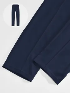 Detail of navy blue men's casual joggers showing fabric texture and straight leg cuff.