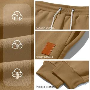 Detailed macro view of khaki jogger pants showing drawstring, leather patch, and cuffs