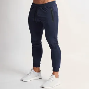 Close-up detail of navy blue slim fit men's joggers with waterproof zipper pocket and cuff