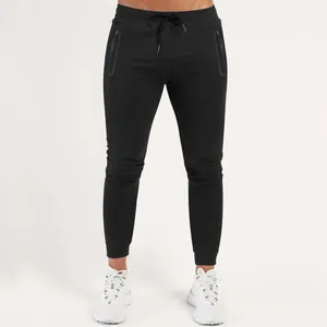 Detailed view of men's black slim fit athletic joggers featuring side zipper pockets