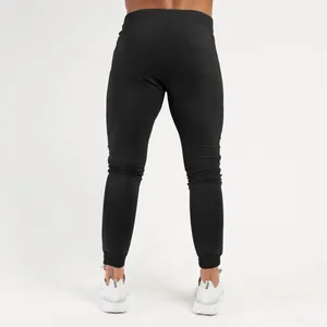 Detailed back view of men's black slim-fit athletic joggers featuring tapered cuffs.