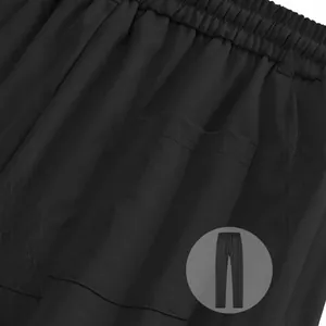 Detail view of black men's twill jogger sweatpants showing waistband and pocket