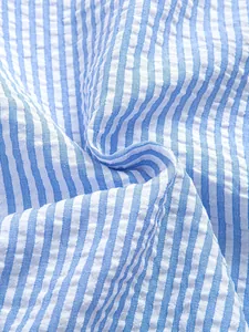 Macro view of blue and white striped seersucker fabric texture for men's vintage shirt
