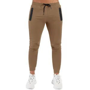 Men's slim-fit joggers in khaki with black zipper pockets for fitness and running.
