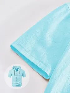Detailed view of the sleeve cuff on a light blue linen texture hooded shirt for men.