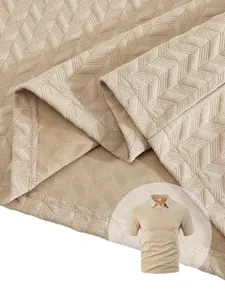 Detail of men's polo shirt featuring beige chevron waffle jacquard fabric texture