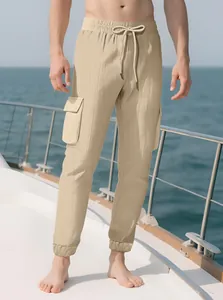 Detail of men's slim fit cargo jogger pants with elastic waist and waffle texture