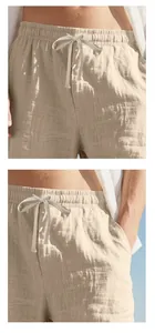 Detail of men's linen drawstring shorts with elastic waist and textured fabric