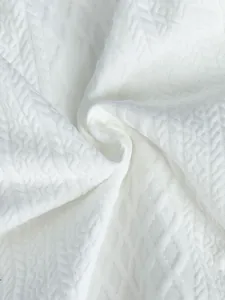 Close-up macro shot of white geometric diamond jacquard fabric texture for men's hoodie