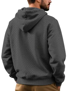 Detail view of the textured jacquard pattern on a men's charcoal grey hoodie.