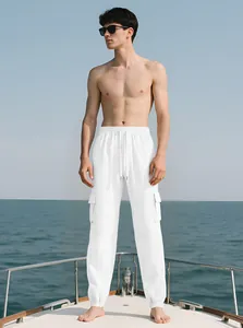 White men's slim fit cargo joggers featuring side pockets shown on a luxury boat deck