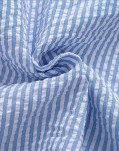 Macro close-up showing the detailed texture of blue and white striped seersucker shirt fabric