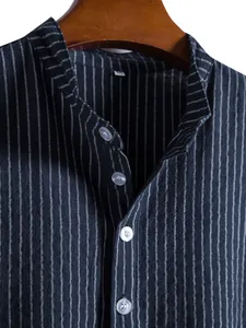 Detailed close-up of a men's navy blue striped shirt featuring a grandad collar and white buttons