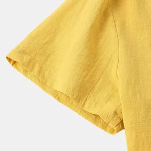Macro view of short sleeve detail on yellow cotton shirt showing breathable fabric texture