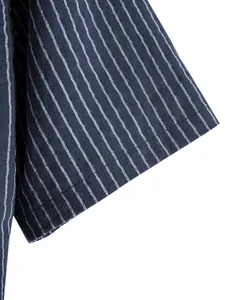 Detailed macro shot of navy blue striped cotton linen men shirt sleeve stitching