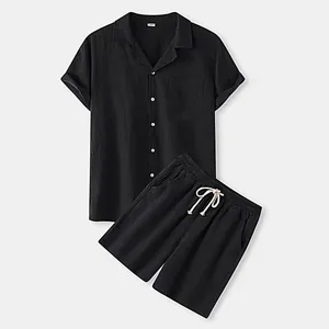 Detail of men's black short sleeve button down shirt and matching drawstring shorts set