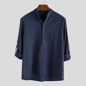 Close-up of navy blue linen shirt with band collar and decorative red stitching details