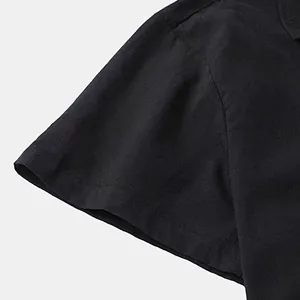 Close-up of black cotton short sleeve shirt showing fabric texture and stitching