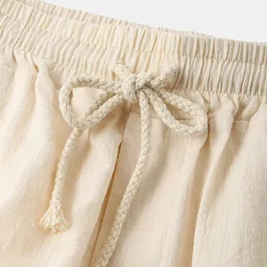 Close-up detail of men's cotton shorts with elastic waist and braided drawstring
