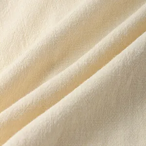 Close-up macro view of high-quality beige cotton linen fabric texture for summer wear