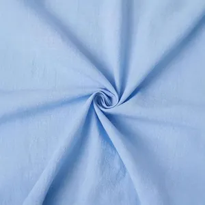 Close-up texture of light blue cotton linen fabric for men's shirts